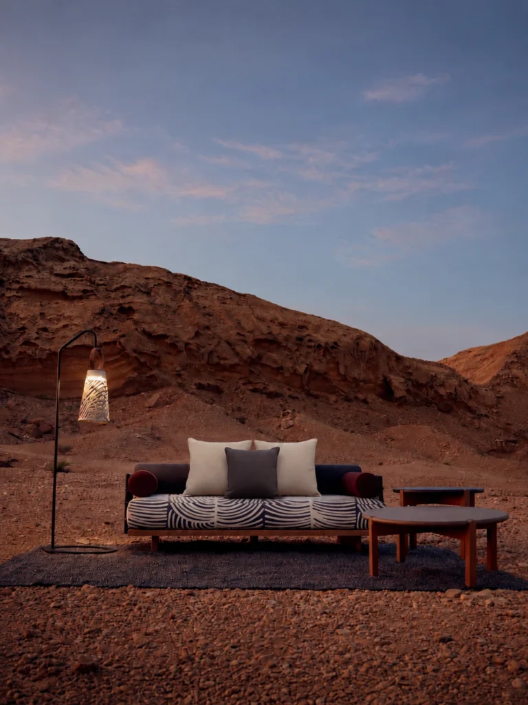 Outdoor sofa set in a desert landscape at dusk