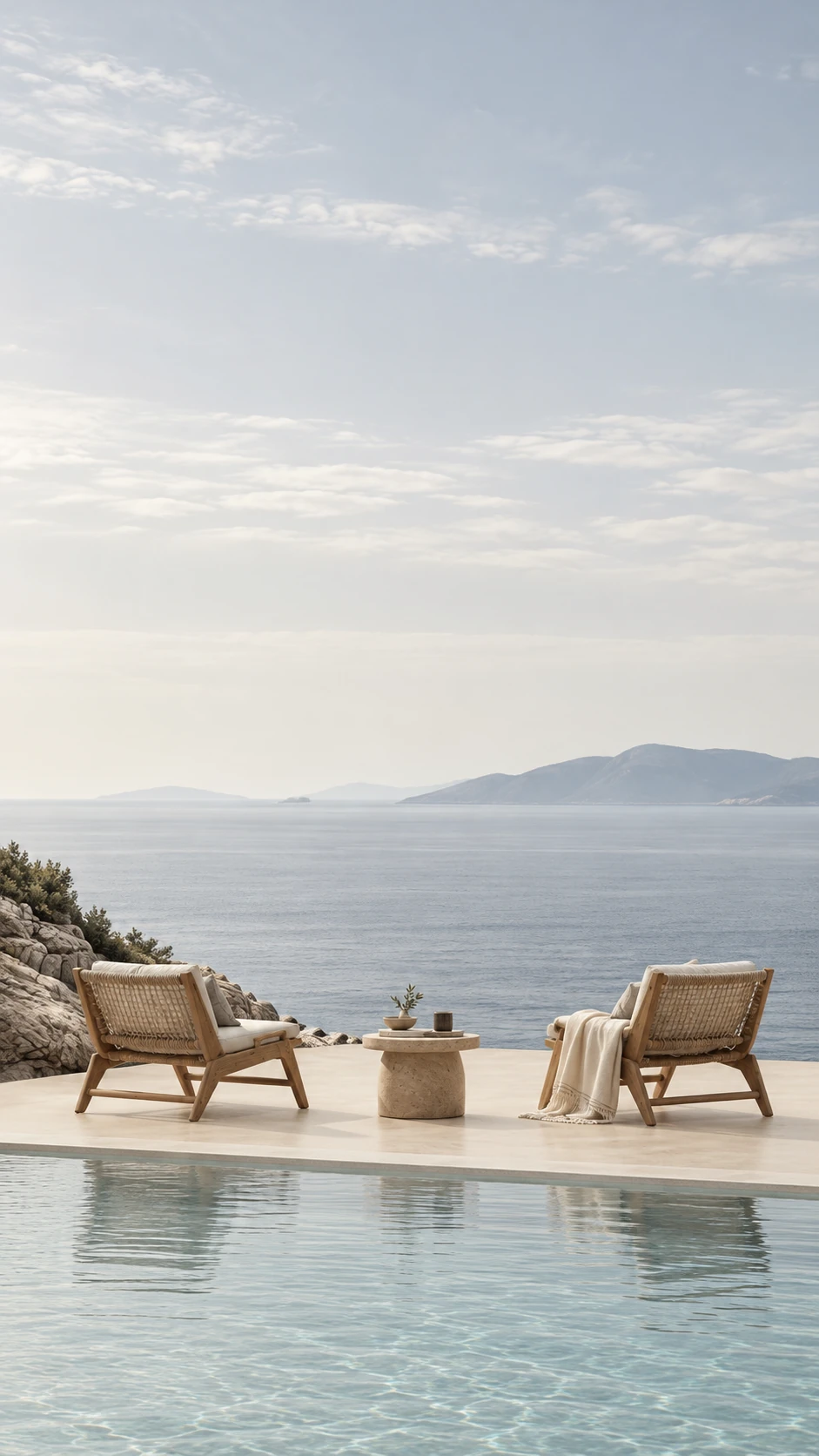 Poolside lounge chairs overlooking the sea